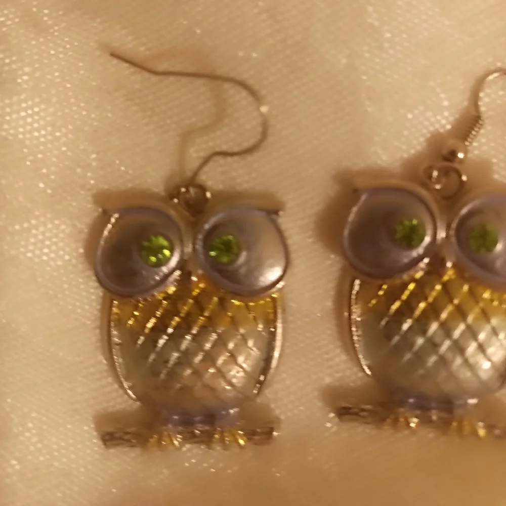 Two toned silver and gold tone green eye owl dangle earrings